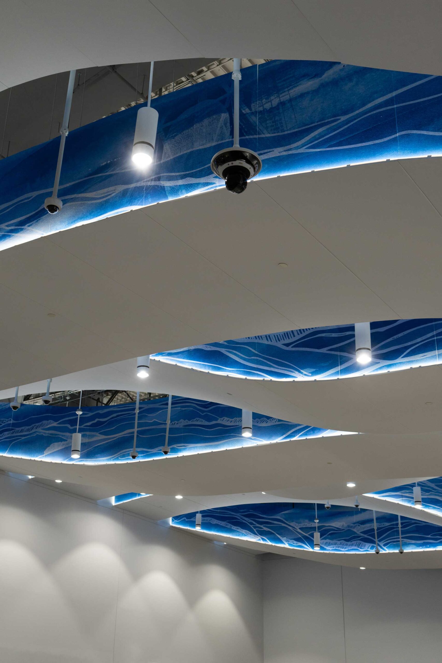 Custom Cloud System with blue illustrations on sides installed to ceiling